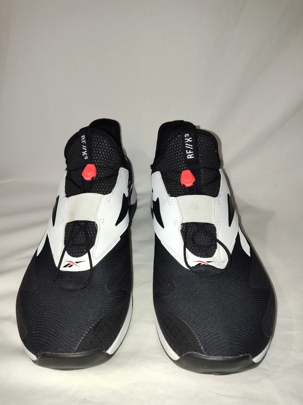 Reebok Men’s Black and White Athletic Slip-On Sneakers
